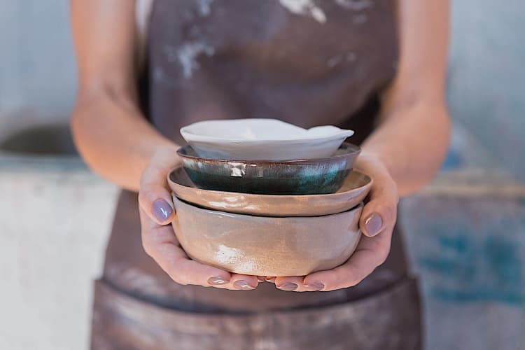 manos cogiendo cuencos de cerámica